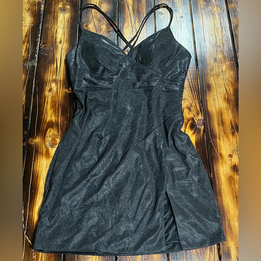 Sparkly black cocktail dress with mini slit and cross straps in the back.